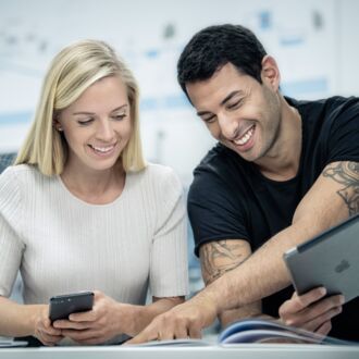 A woman and a man with an iPad in a professional setting