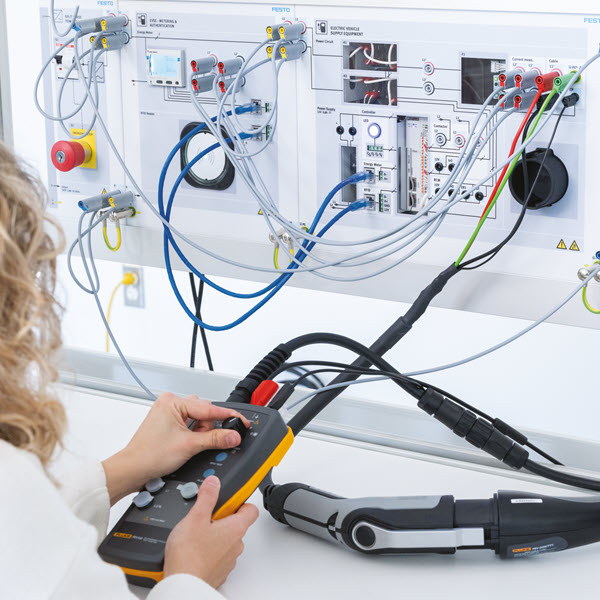 Student using charging station analyzer device 